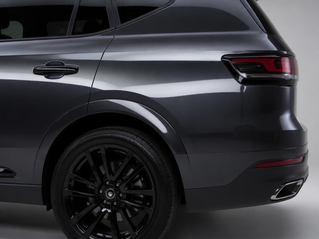 The same SUV rear quarter panel after a factory-matched respray